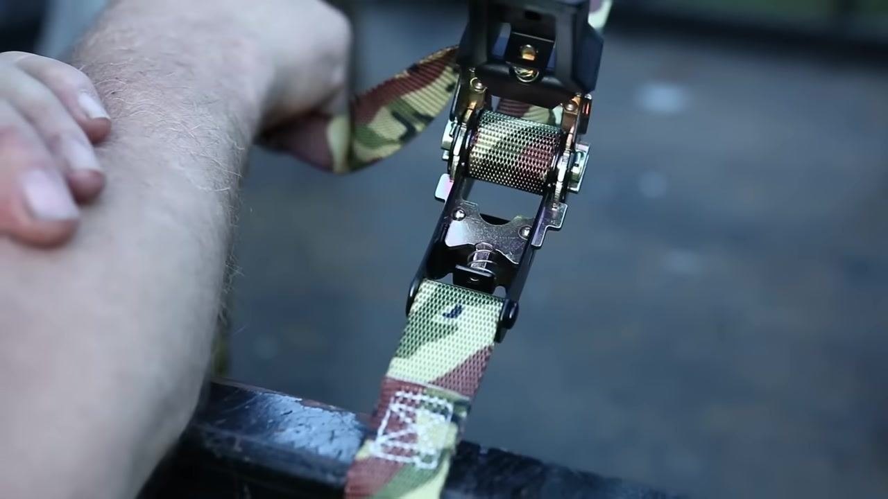 Close-up of the ratchet mechanism showing the windlass, strap, and lever attachment, highlighting the cam shape.